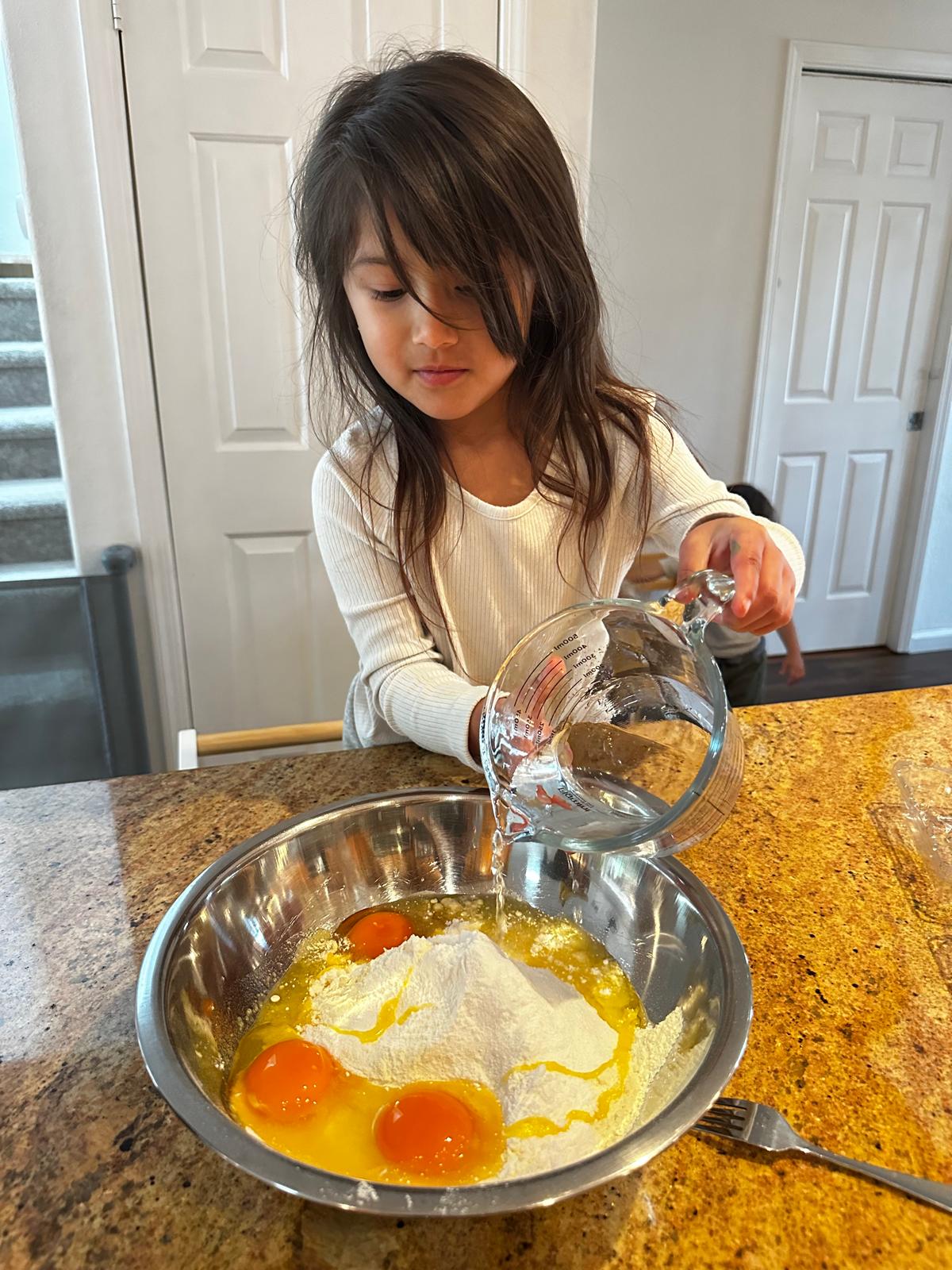 Child helping prepare a meal at Seed To Bloom